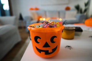 Bucket in a pumpkin shape, full with candy after Trick or Treat