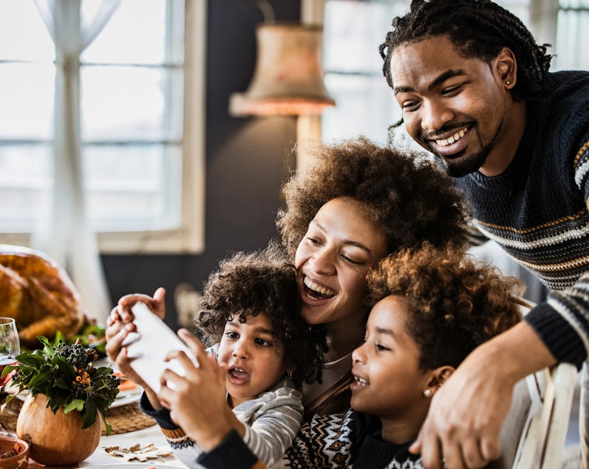 Family having fun while taking a selfie on Thanksgiving in a list of thanksgiving turkey instagram c...