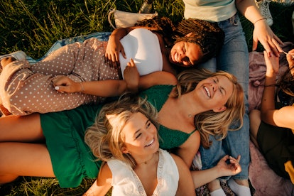 Group of friends laughing, since fire signs are passionate and creative.