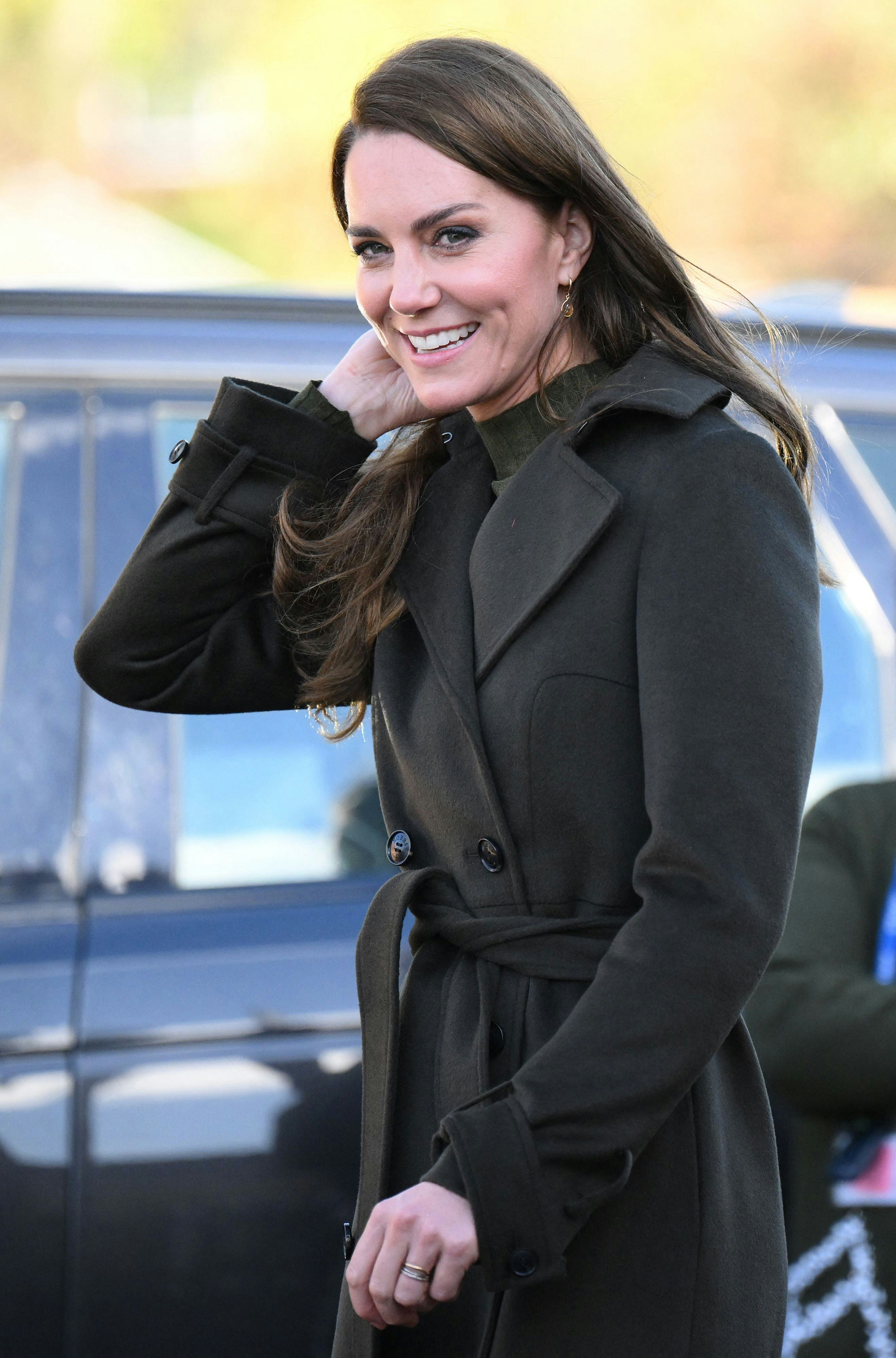 Kate Middleton wearing a dark green outfit.