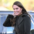 Kate Middleton wearing a dark green outfit.