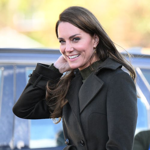 Kate Middleton wearing a dark green outfit.