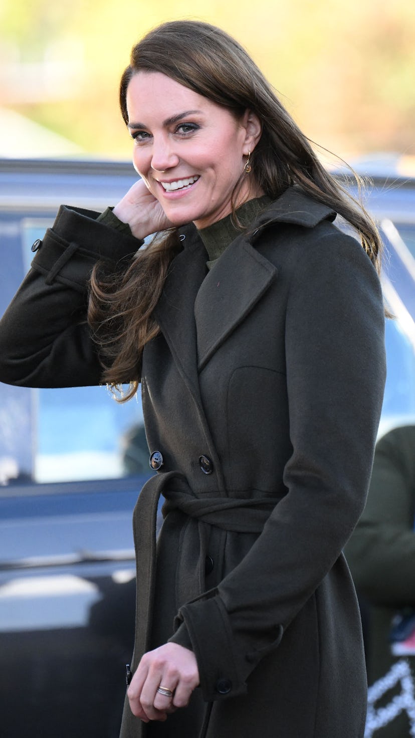 Kate Middleton wearing a dark green outfit.