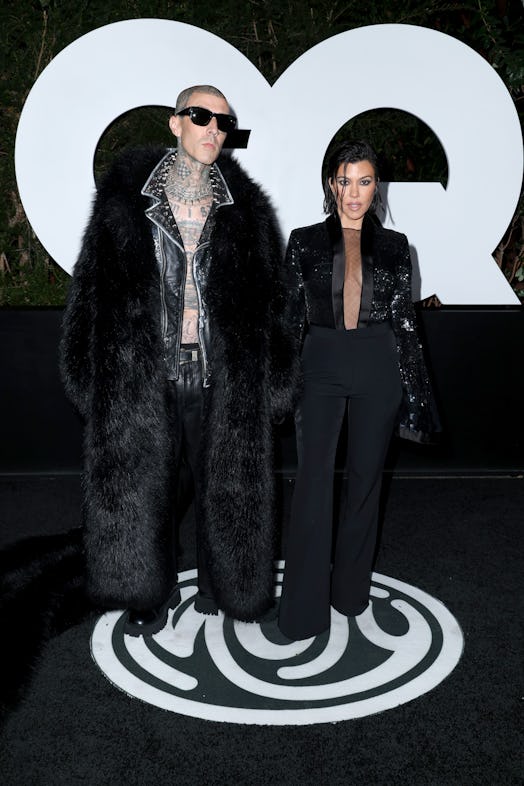 Travis Barker and Kourtney Kardashian Barker wearing matching black outfits at the 2022 'GQ' Men of ...