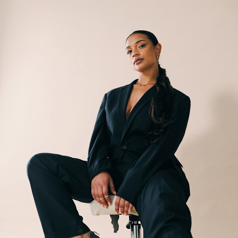 A young woman strikes a pose with her leg extended toward camera, as she discusses the retrograde pl...