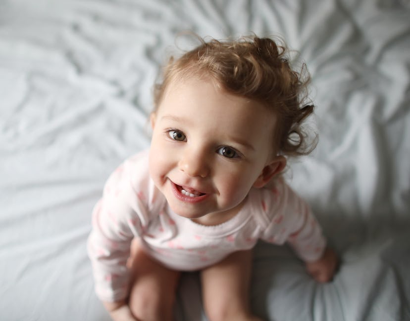 cute toddler girl smiling in a list of baby names that start with K