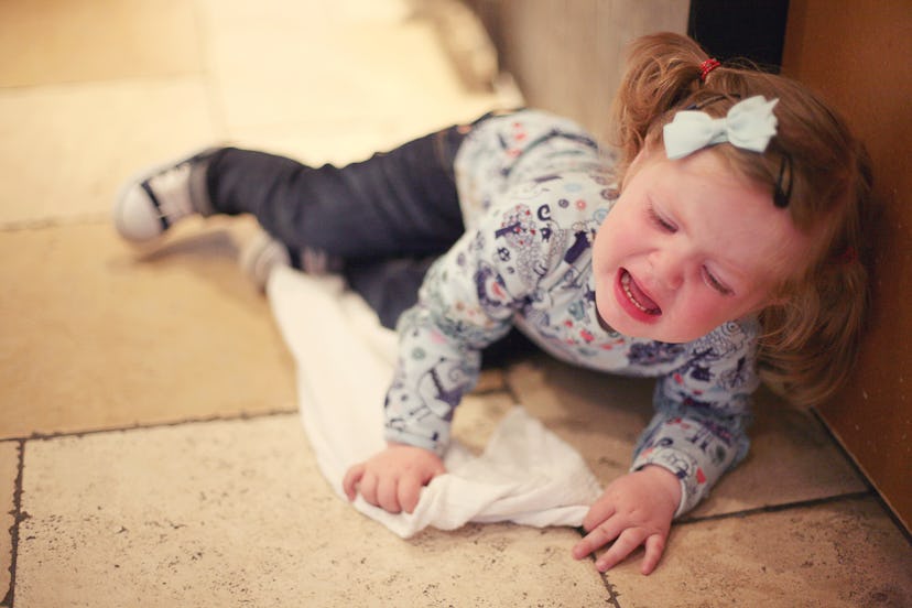 Toddler throwing herself on ground during tantrum