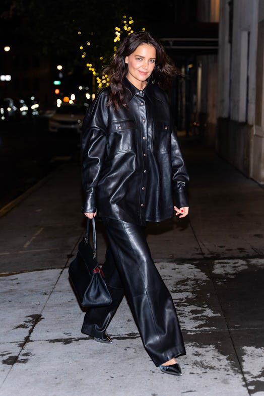 Katie Holmes walking in Midtown in an all black leather outfit.