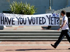 Students stroll past an Election Day rally on Sproul Plaza organized by the CALPIRG students organiz...