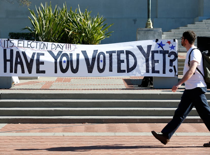Students stroll past an Election Day rally on Sproul Plaza organized by the CALPIRG students organiz...