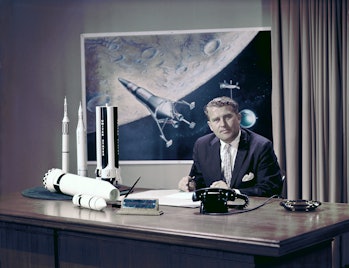 Photo of Marshall Space Flight Center (MSFC) Director Dr. Wernher von Braun at his desk with moon la...
