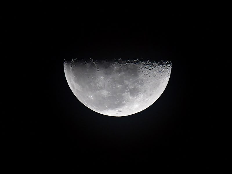 TOPSHOT - A half moon rises as the Artemis I unmanned lunar rocket prepares to lift off from pad 39B...