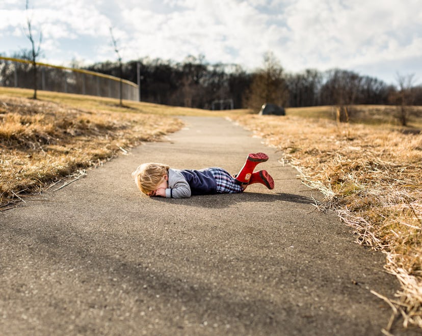 a crying toddler in an article about why do toddlers throw themselves on the ground?