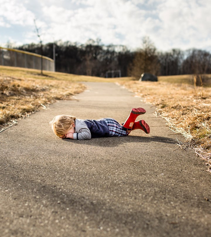 a crying toddler in an article about why do toddlers throw themselves on the ground?