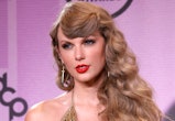 Taylor Swift attended the American Music Awards 2022 with red lipstick and a disco-inspired hairstyl...