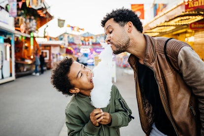 A father and son spending the day at the fun fair in article about the four parenting styles 