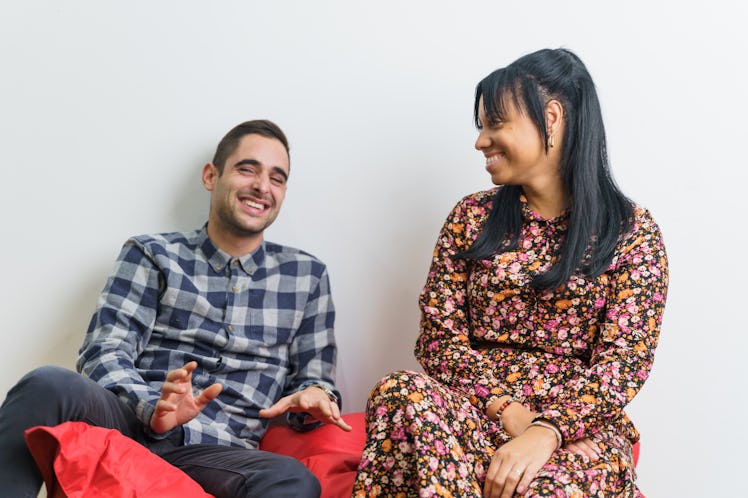 Two co-workers of different ethnicities talking and having fun after work
