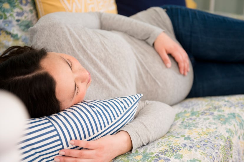 a pregnant person resting in an article about pelvic pain during pregnancy