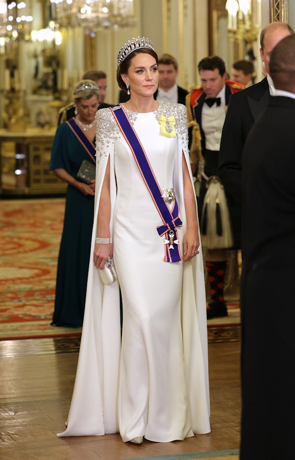 Kate Middleton wearing a white cape dress from Jenny Packham.