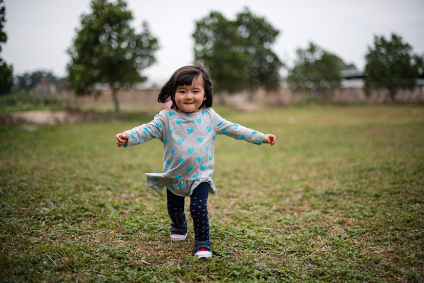 Toddler girl running towards camera on the lawn joyfully in a list of baby girl "L" names