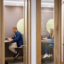 Latin American business people working in private cubicles at a coworking office