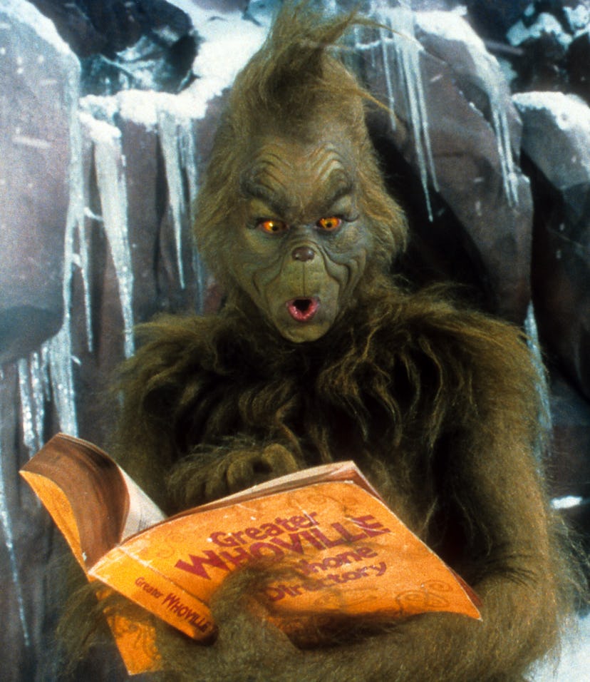 Jim Carrey looking through phone directory in a scene from the film 'How The Grinch Stole Christmas'...