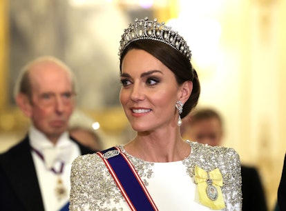 Kate Middleton, wearing the Lover's Knot tiara and Princess Diana's earrings, attends a state banque...