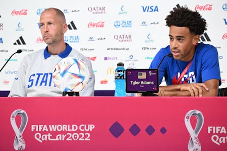 USA's midfielder Tyler Adams (R) and coach Gregg Berhalter give a press conference at the Qatar Nati...