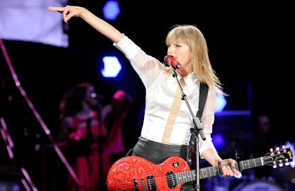 Taylor Swift performing at a concert, which has Taylor Swift VIP tickets. 