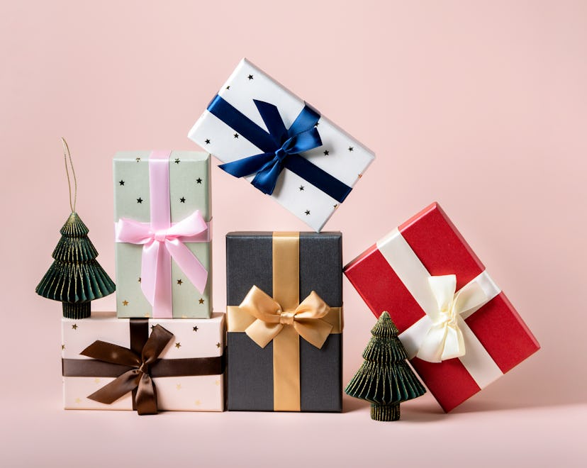 a shot of a stack of beautifully wrapped christmas holiday presents to represent best christmas gift...