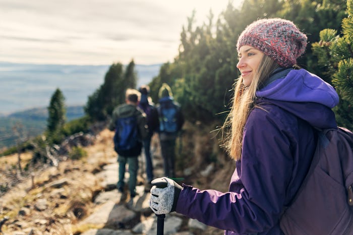 Family is hiking in the Tatras - Slovakia. They are walking on the difficult stone path high in the ...