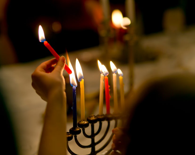Lighting Hanukkah candles and breaking bread, Challah in a list of best Hannukah pajamas
