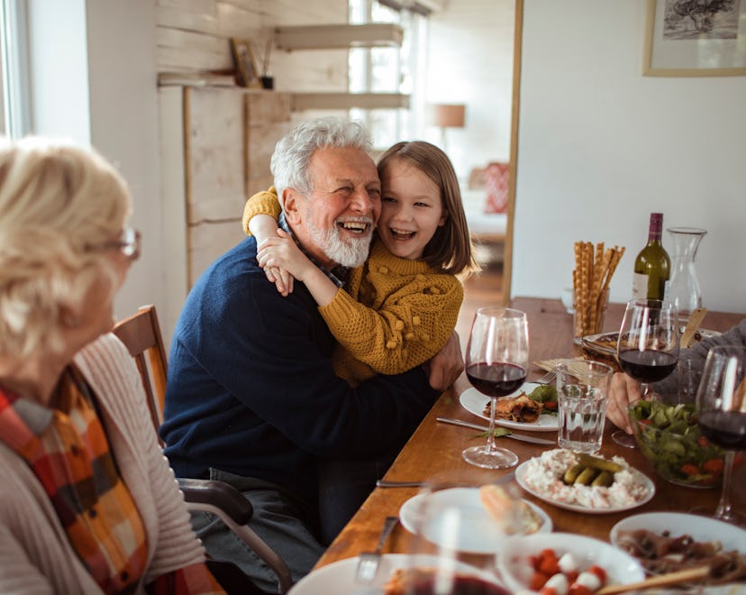 a little girl with her grandparents during the holidays in a round up of last minute gifts for grand...