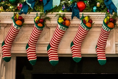 Christmas stockings decorate the fireplace mantle in the State Dining Room of the White House.