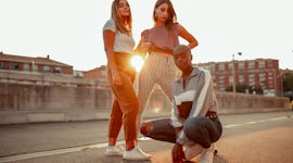 three friends pose for a photo during golden hour as they chat about their november 14, 2022 weekly ...