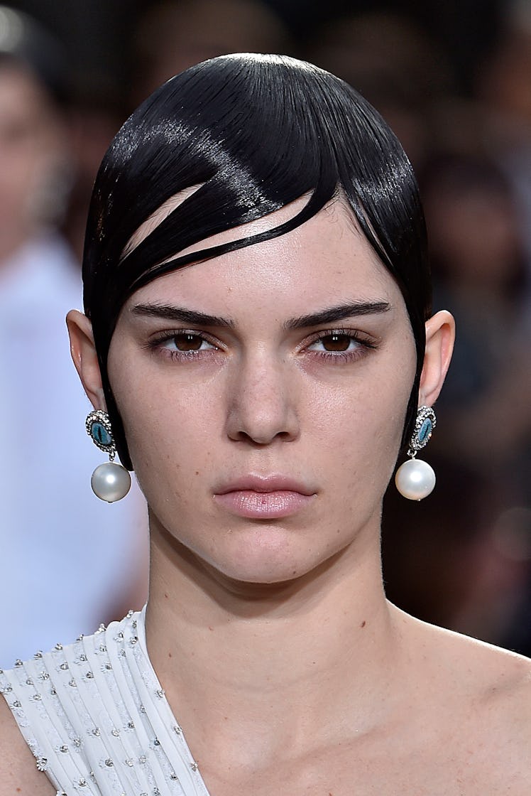 Kendall Jenner Beauty Evolution: Kendall Jenner with slick side bangs walks the runway during the Gi...