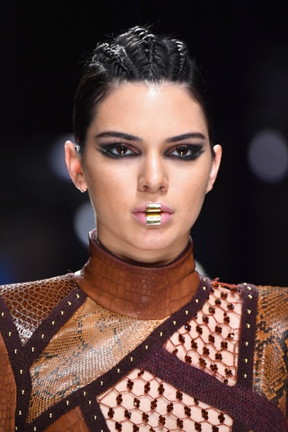 Kendall Jenner Beauty Evolution: Kendall Jenner, with braids and a faux piercing, walks the runway d...