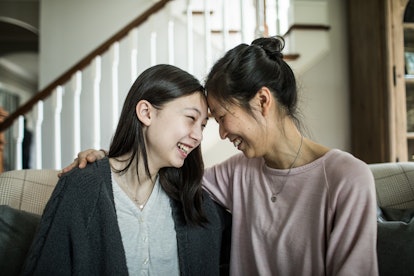 Mother and teenager talking at home in an article about can you adopt an adult?