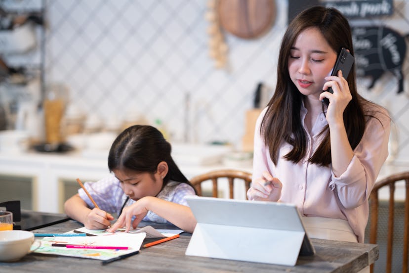 Working mother raising daughter while working at home