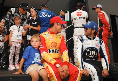 WATKINS GLEN, NEW YORK - AUGUST 21: Joey Logano, driver of the #22 Shell Pennzoil Ford, (L) and son...