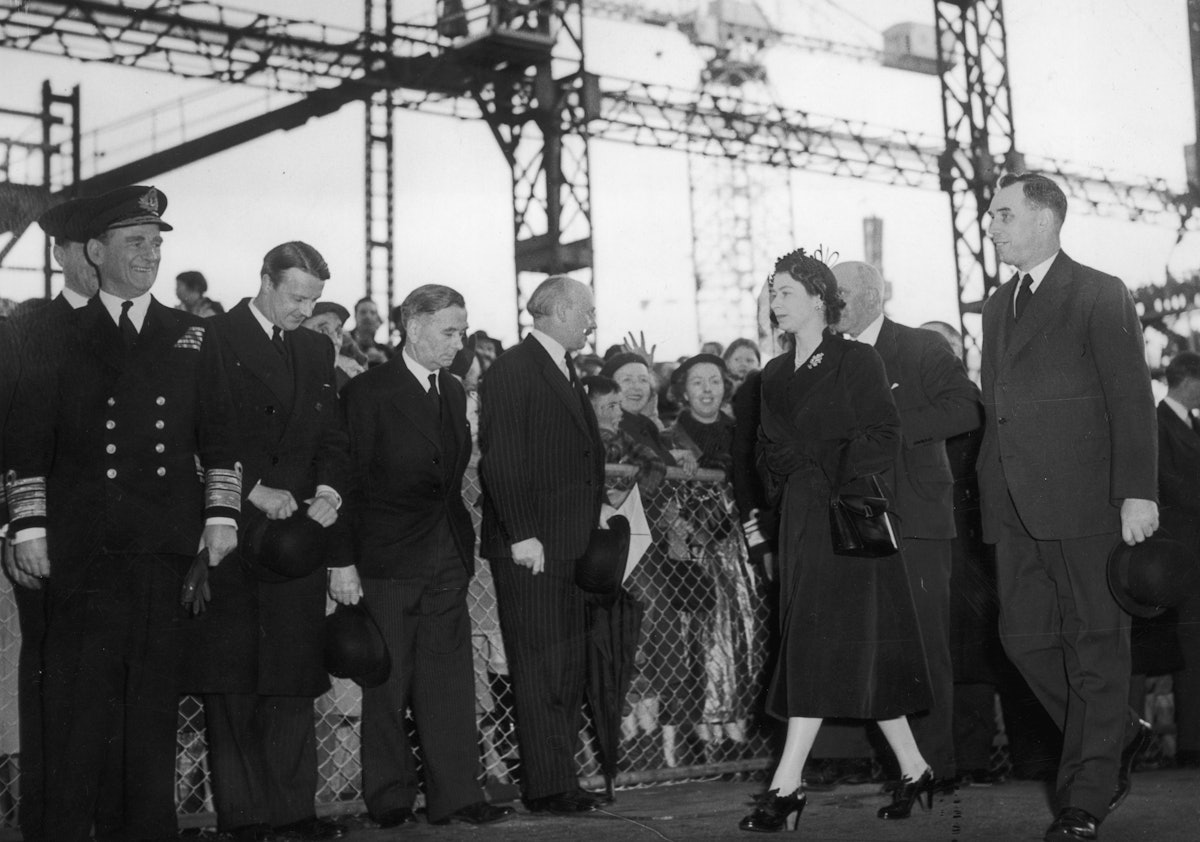 16th April 1953:  Queen Elizabeth II on her way to perform the launching ceremony of the new Royal Y...