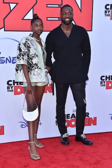 Former professional basketball player Dwayne Wade (R) and his daughter Zaya Wade arrive for the "Che...