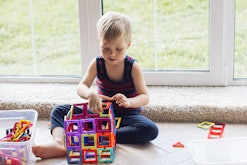 A child playing with a set of Magnatiles, one of the top toys for 3-year-olds.