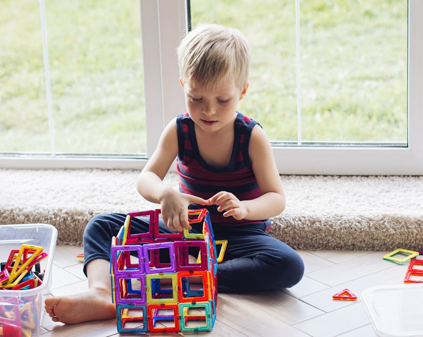 A child playing with a set of Magnatiles, one of the top toys for 3-year-olds.