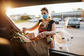 Mother with baby in shopping wearing a mask