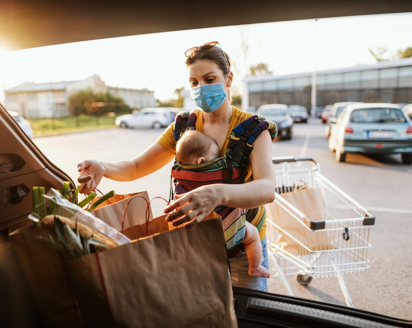 Mother with baby in shopping wearing a mask