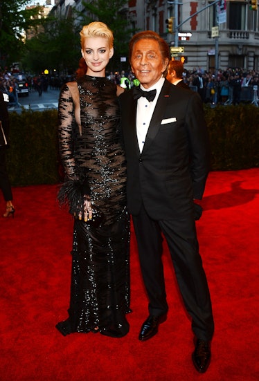 Anne Hathaway (L) and designer Valentino Garavani attends the Costume Institute Gala