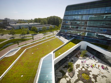 View form rooftop to inner courtyard garden, green roof and city context. Astellas Offices - Mirai H...