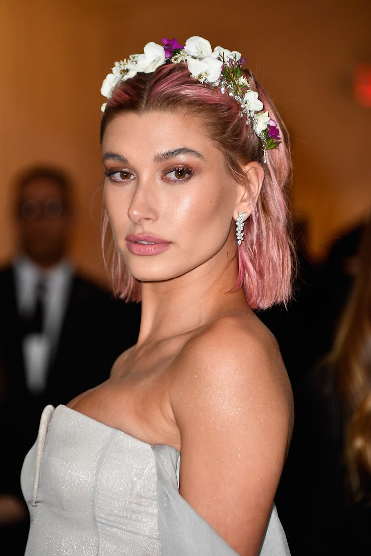 Hailey Bieber's Beauty Evolution: Hailey Baldwin, with pink hair, attends the Heavenly Bodies: Fashi...