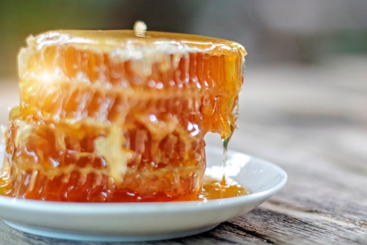 Honeycomb and honey drops closeup